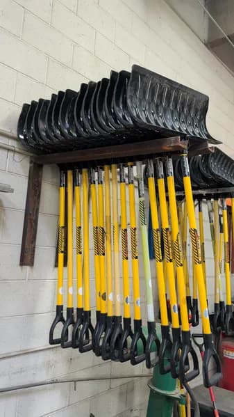 Lot of 15 Snow Shovels with Wall-Mount Rack Storage, side view