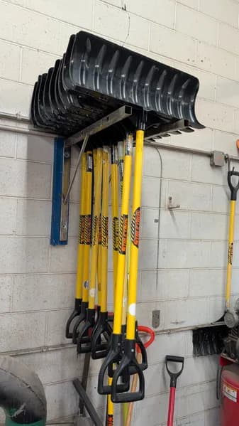 Lot of 10 Snow Shovels with Wall-Mount Storage Rack, primary view