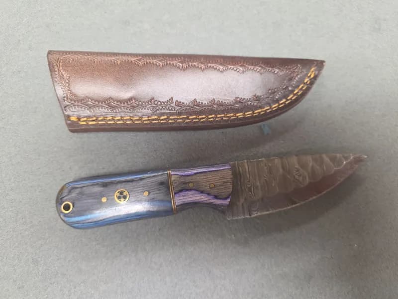 Fixed Blade Knife with Pattern-Welded Style Blade, Blue Laminated Wood Handle & Leather Sheath, side view