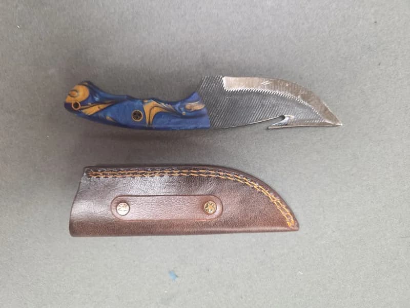 Fixed Blade Gut Hook Knife with Blue and Amber Resin Handle and Leather Sheath, rear view