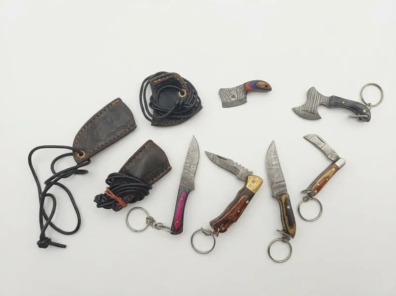 Lot of 6 Miniature Damascus-Pattern Style Keychain Knives & 3 Sheaths, primary view